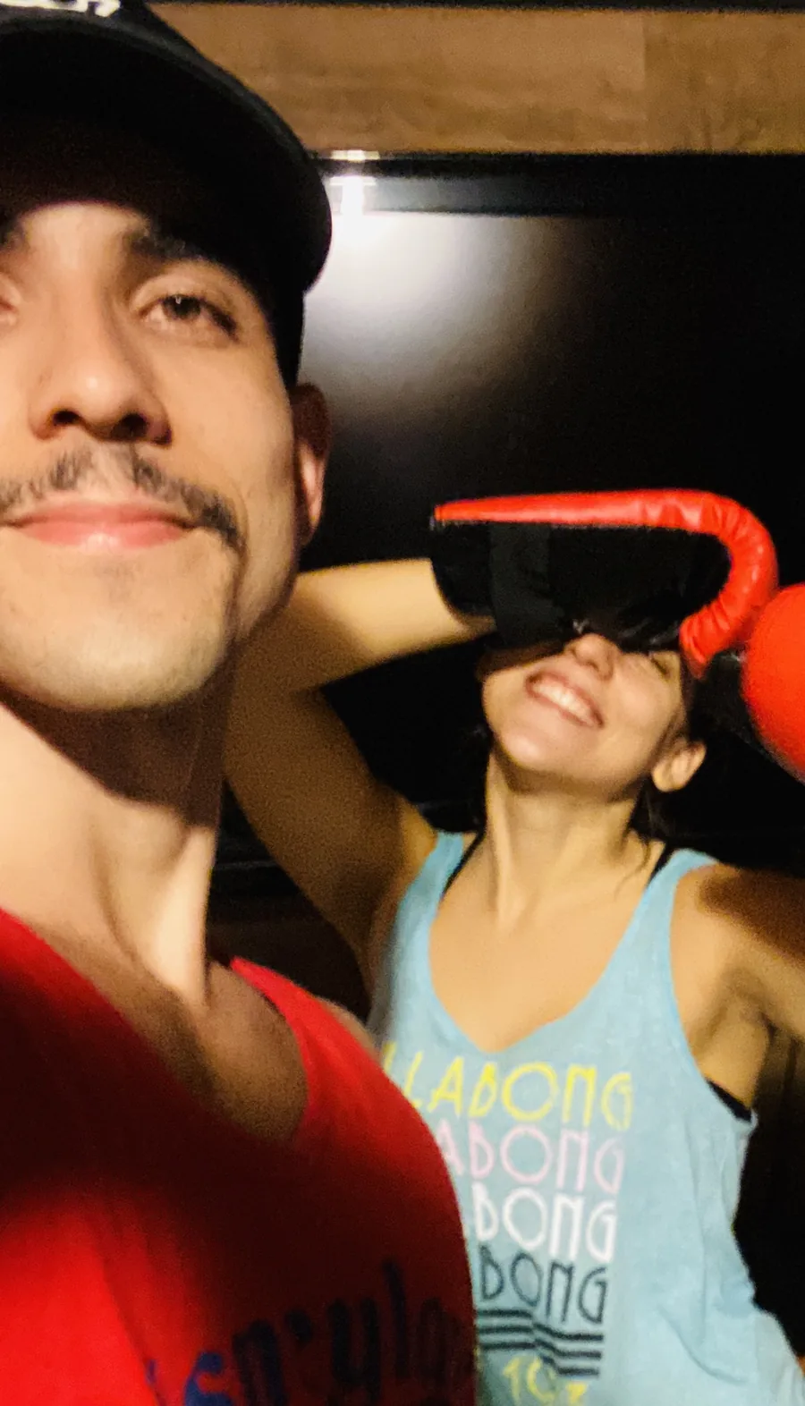 Raphael taking a selfie with a client wearing red boxing gloves